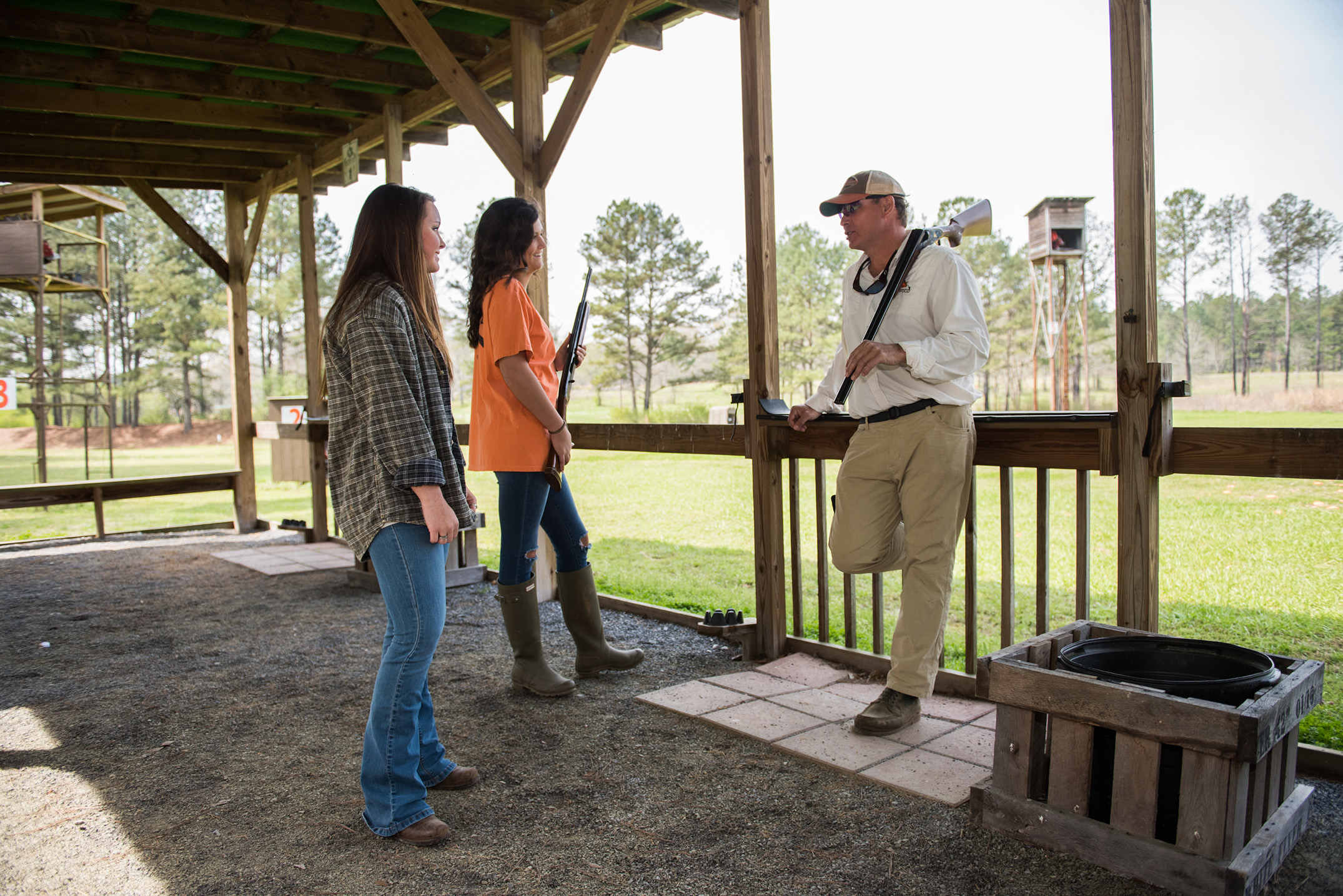 women at gun range learning to shoot